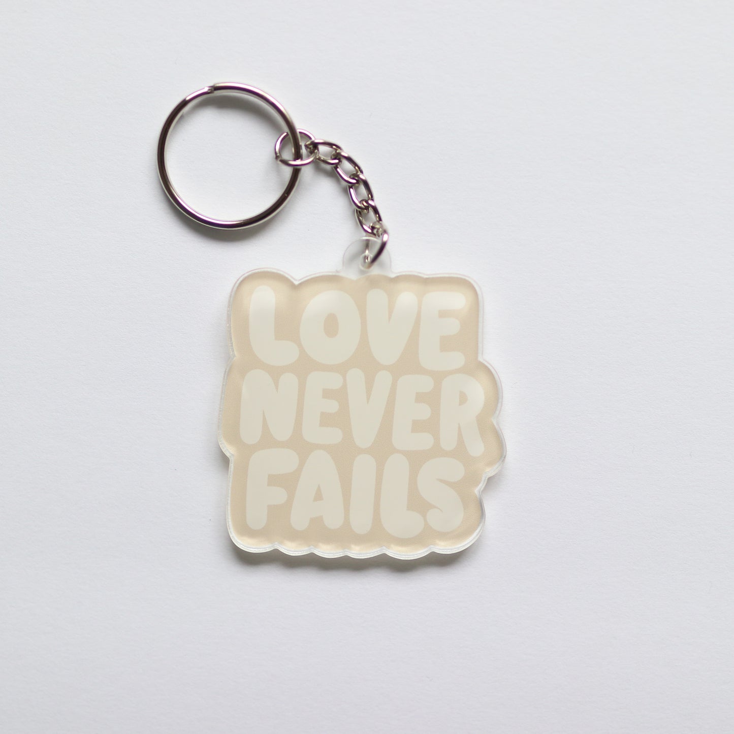 Love Never Fails Acrylic Keychain